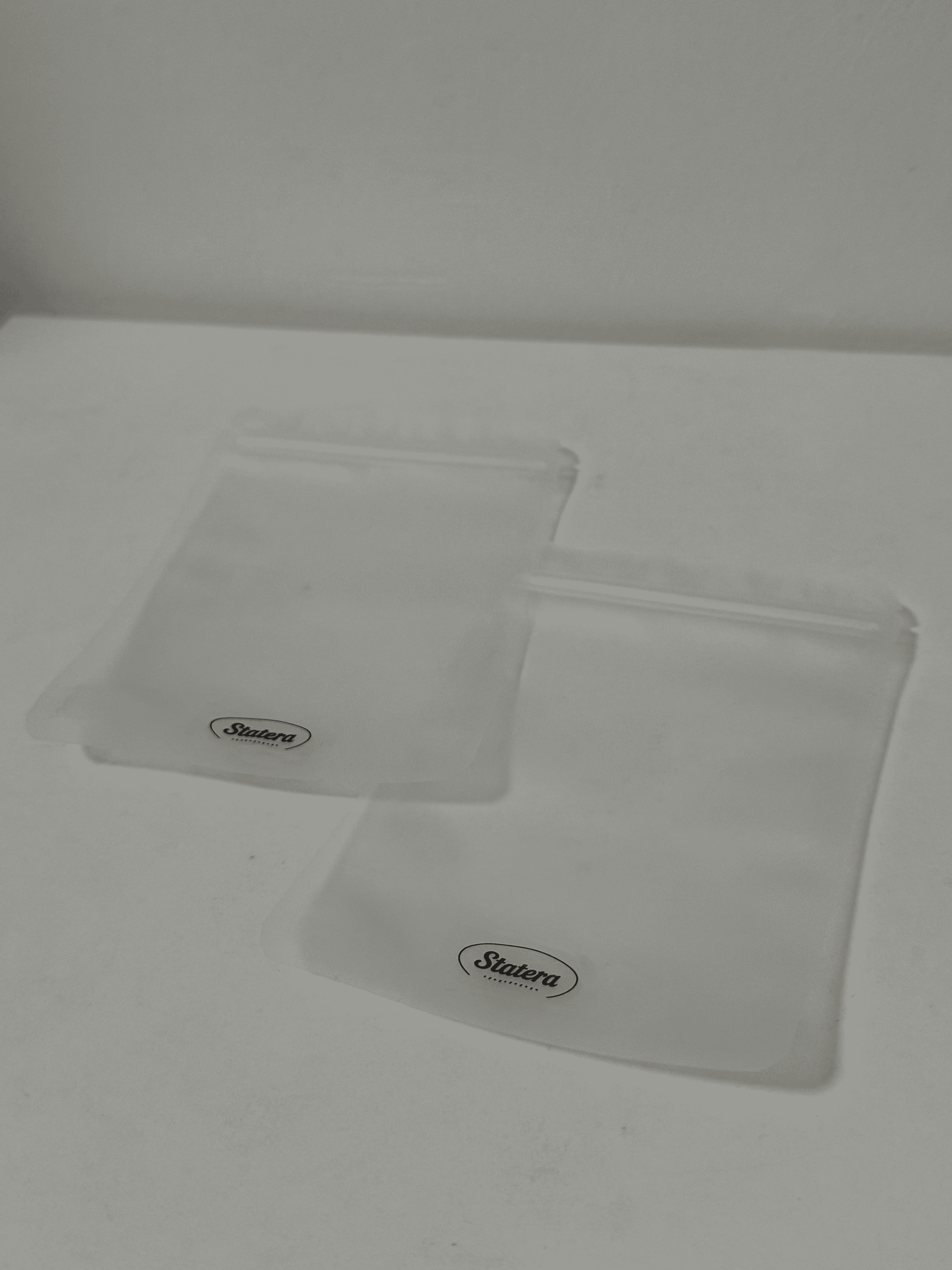 Two translucent STATERA resealable pouches on a white surface